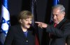 Merkel-Netanyahu-Hitler-moustache-Marc-Sellem.jpg